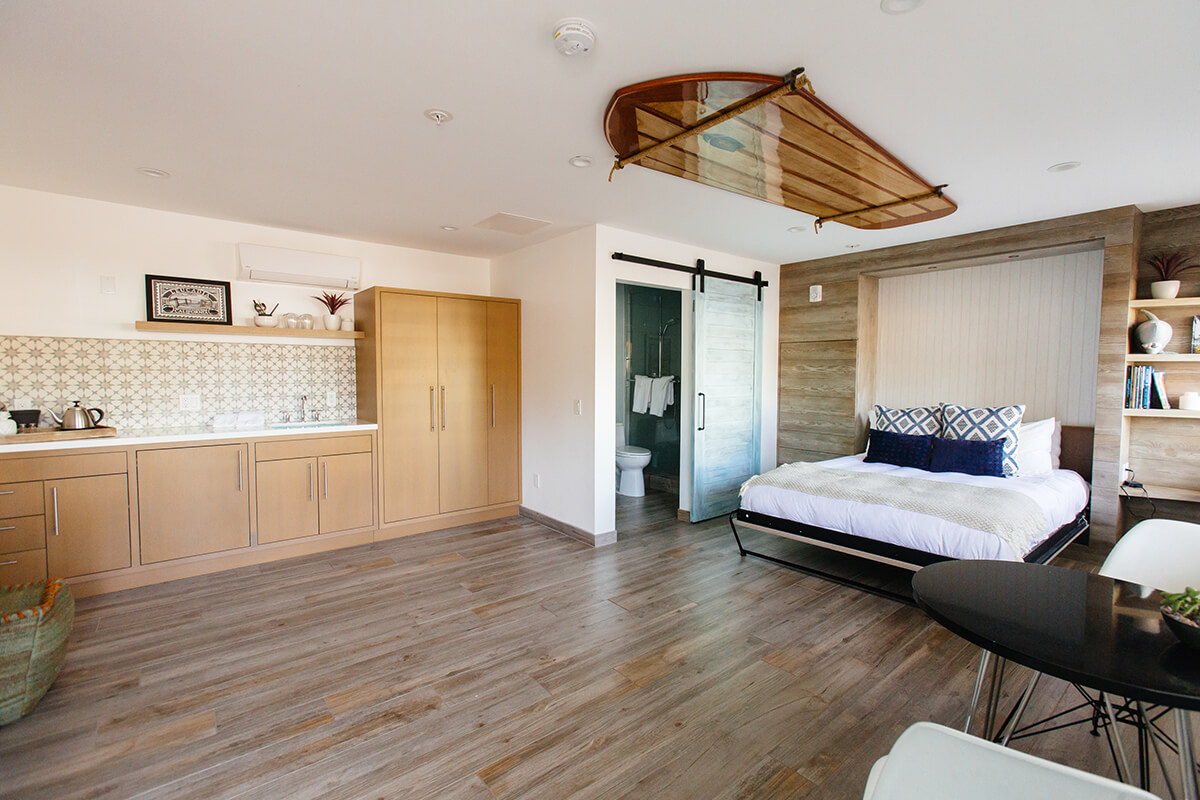 photo of Room 1 beacons with queen bed, sink and bathroom