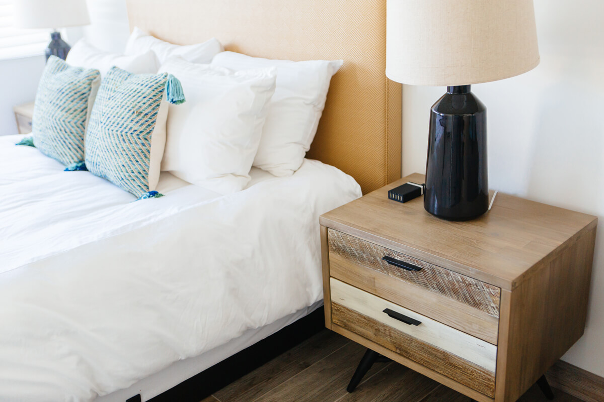 photo of details of nightstand and decor pillows in room 8