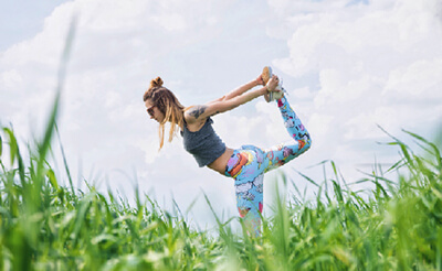 woman doing yoga in a field