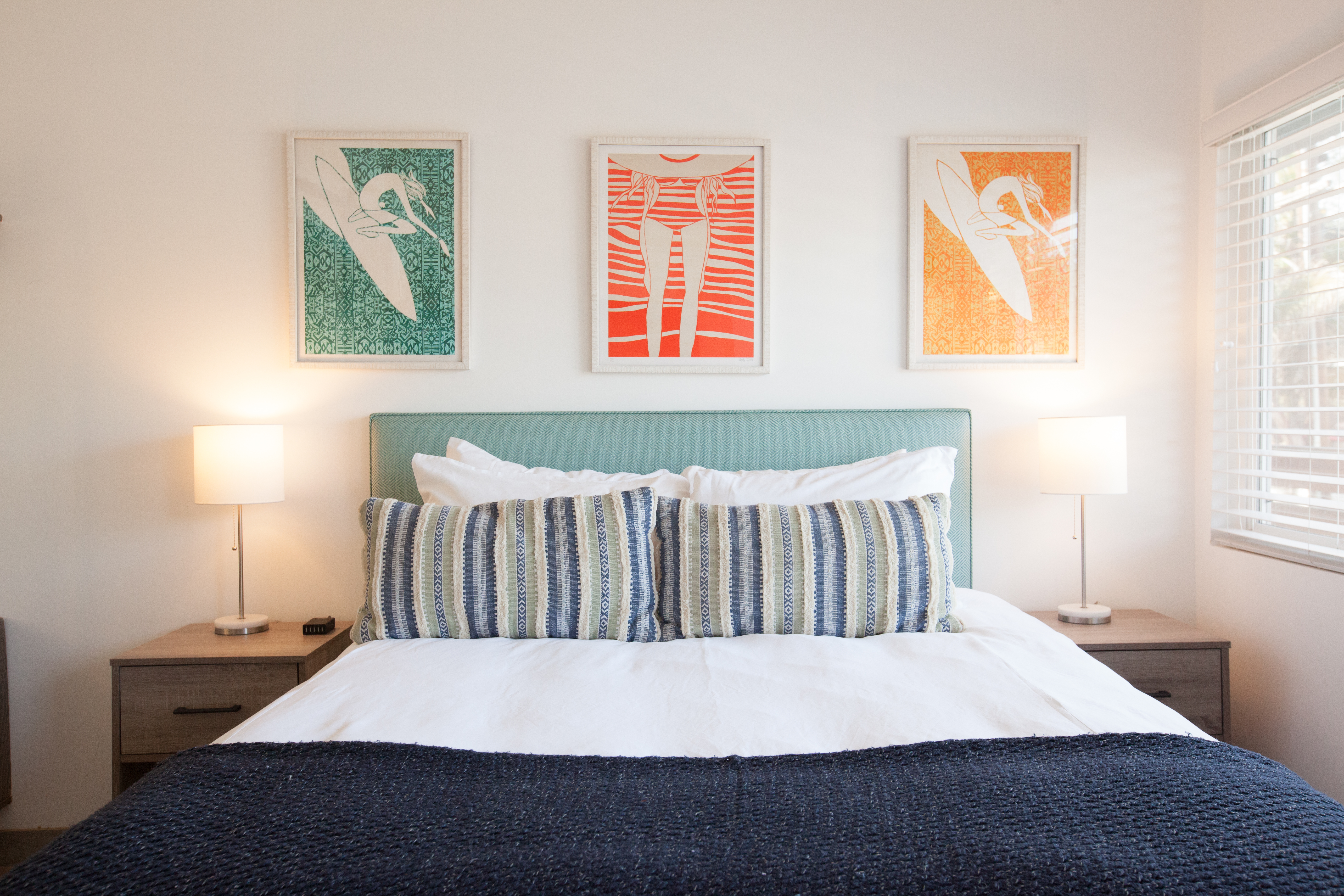 photo of queen bed and artwork in room 7